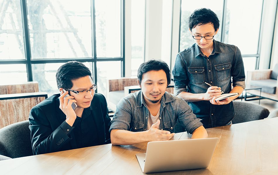 Three young Asian coworkers or college students in serious busin | PC Systems Around You, LLC